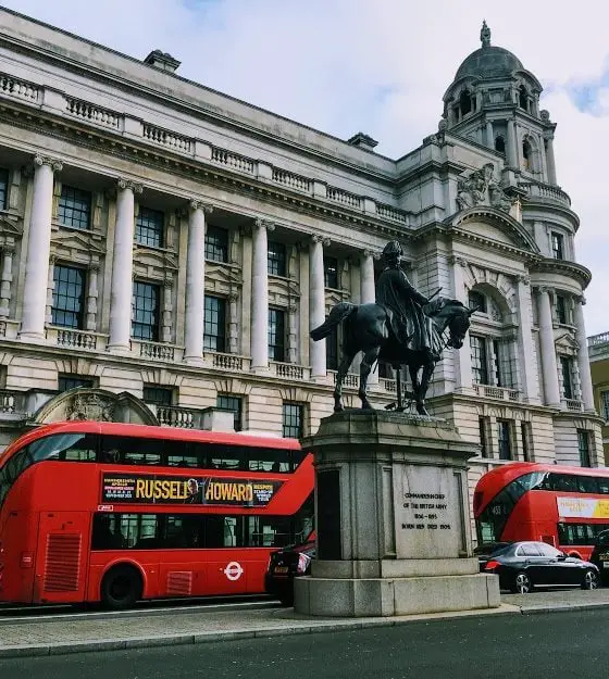 Red London buses driving past the banqueting house in January 2020