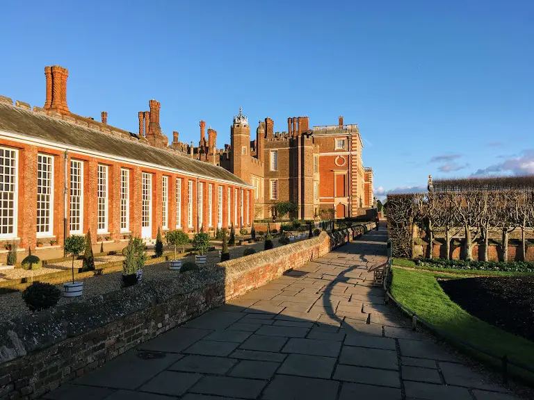 The red brick exterior of Hampton Court Palace in the late afternoon sun in winter. This is one of the most famous palaces in London.