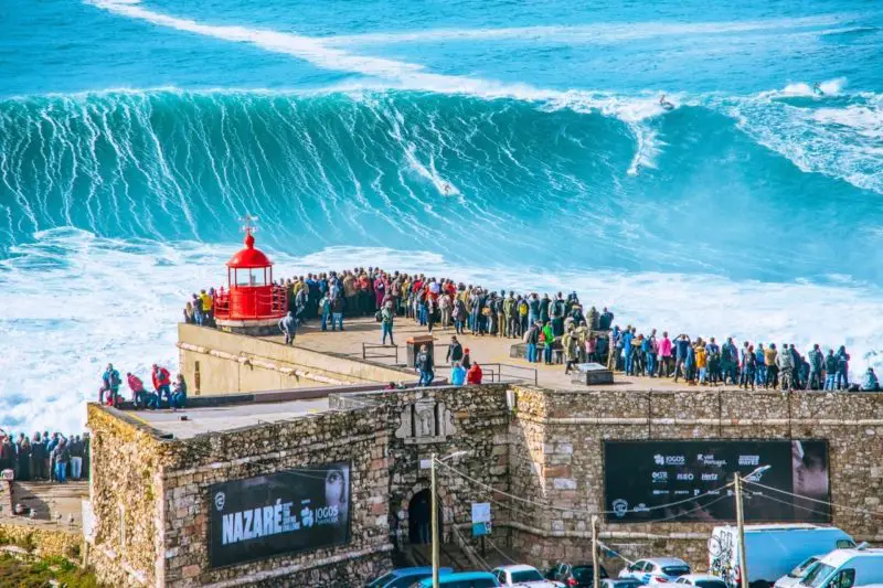 Watching the big waves surfing in Nazare Portugal