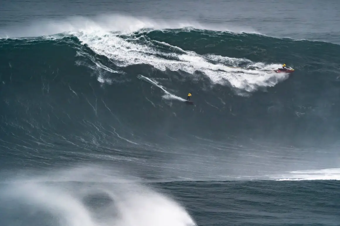 Big wave surfing during big waves season in Nazare, Portugal