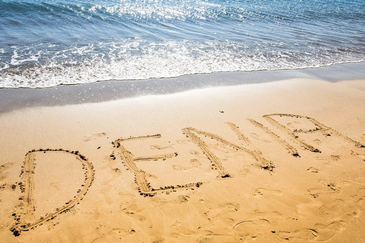 Denia written in the sand at a beach in Spain