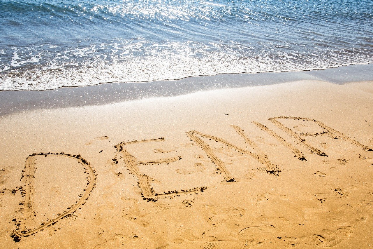 "Denia" written in the sand at one of the beaches in Denia, Spain