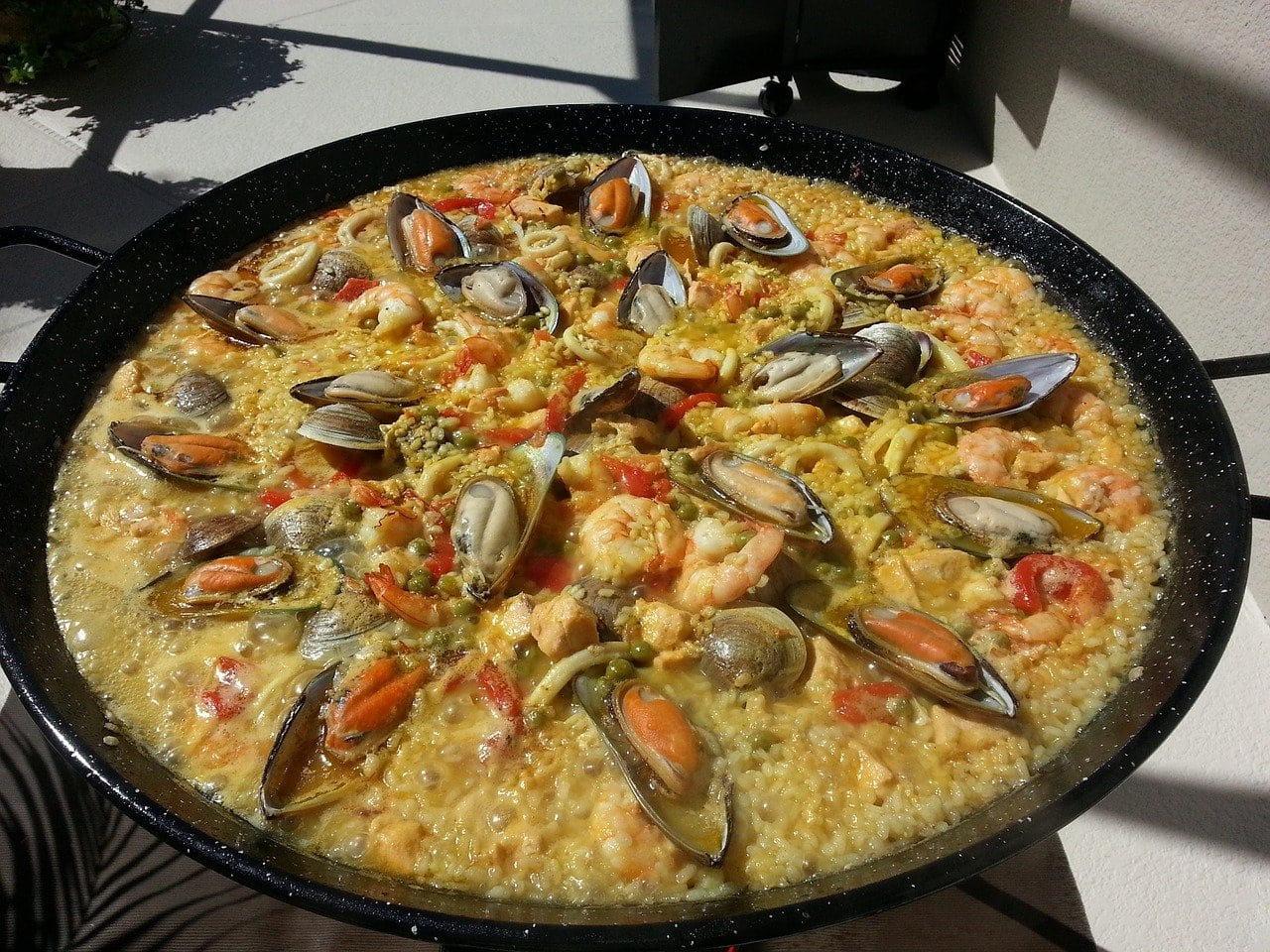 A huge pan of authentic Valencian paella with mussels and prawns.