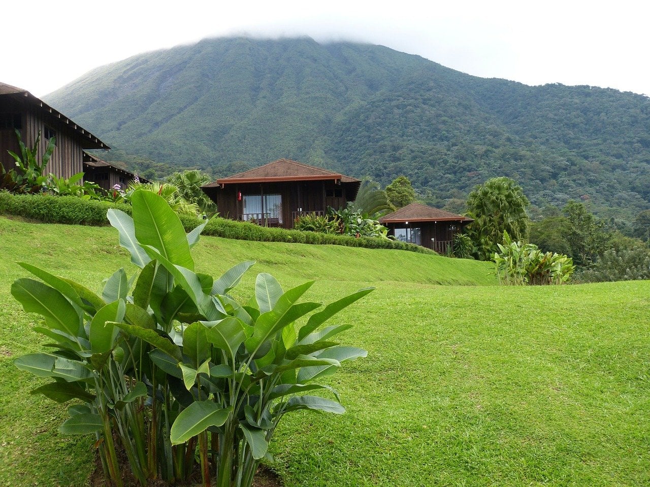 Wooden huts in front of a volcano