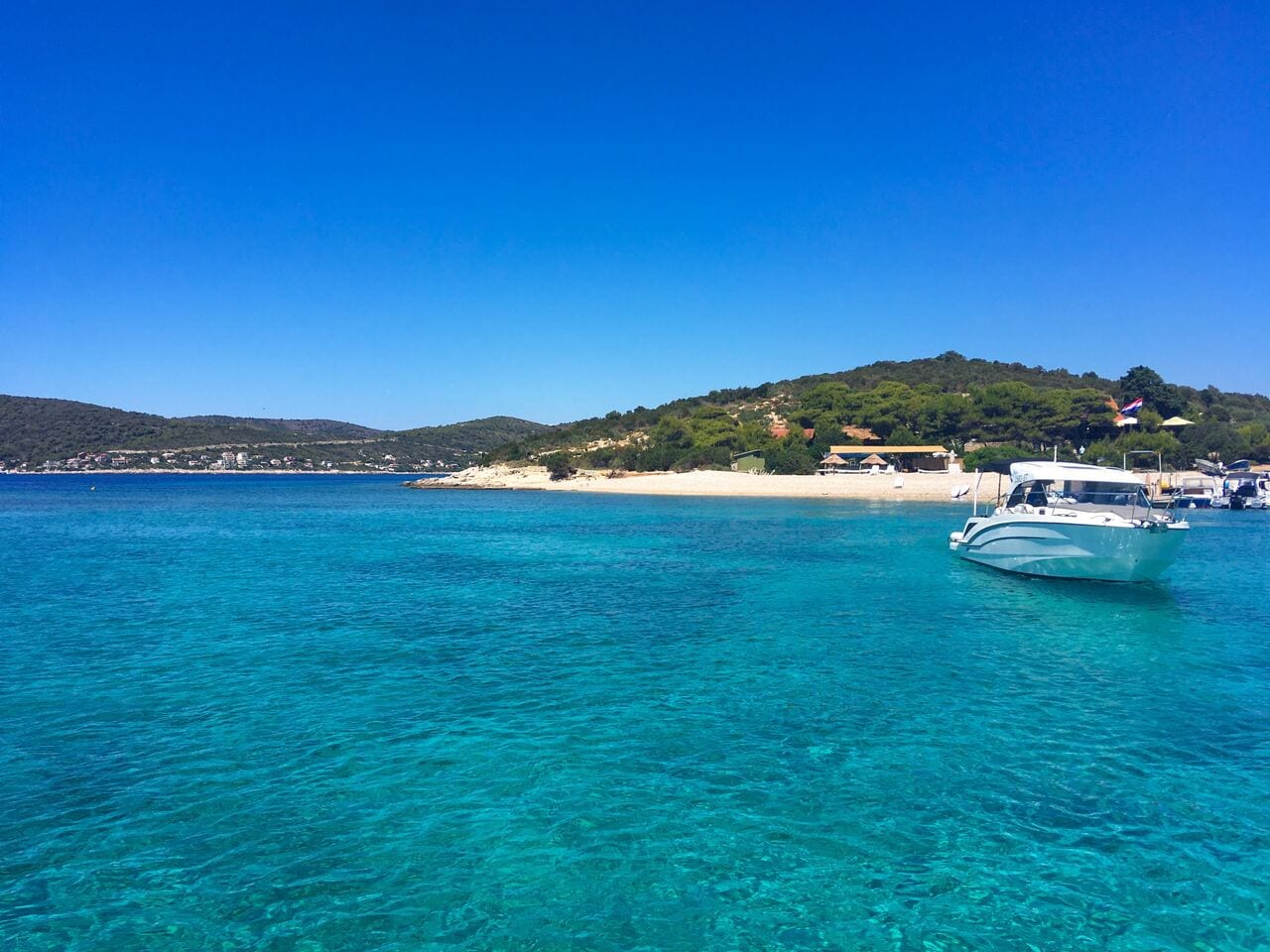 The Blue Lagoon in Croatia, with the islands of islands of Veliki and Krknjasi in the background. The Blue Lagoon is just a short trip away from Split, making it a popular day trip.