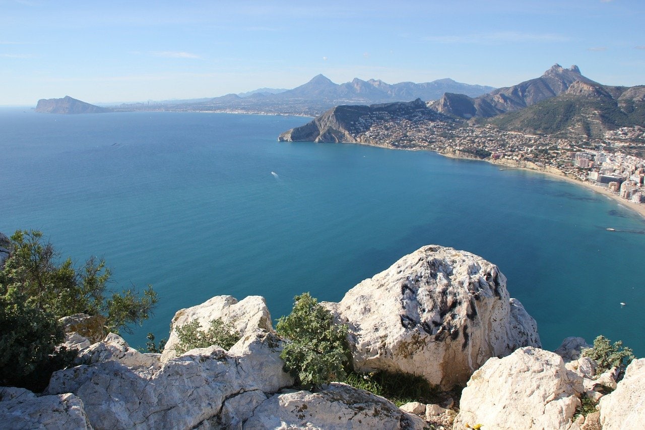 View of the town, coastline and beaches of Alicante from the clifftop. Alicante is one of the most popular day trips from Denia.