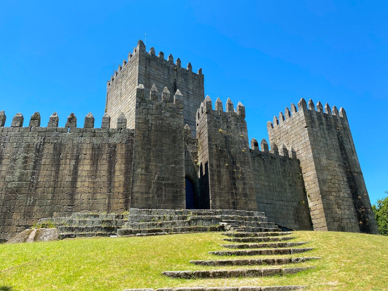 Guimaraes Castle in summer, a day trip you can do during a long weekend in Porto