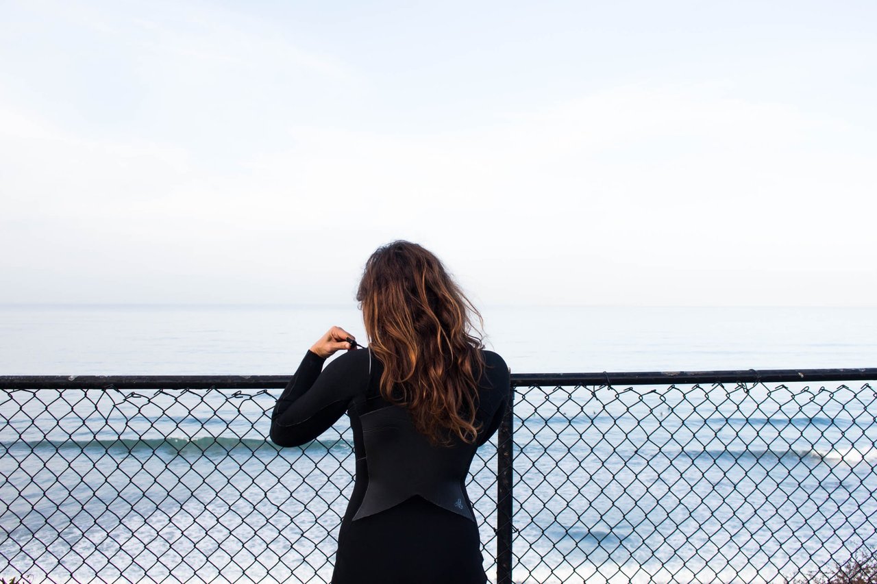 Female surfer wearing a wetsuit