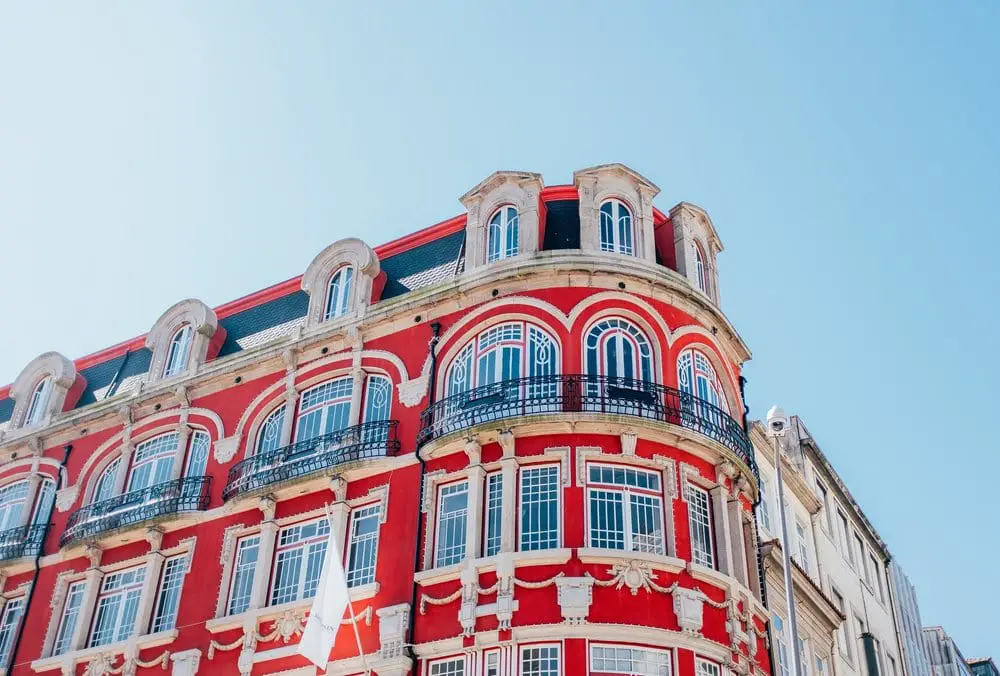 Beautiful bright red building against blue sky in Porto Portugal