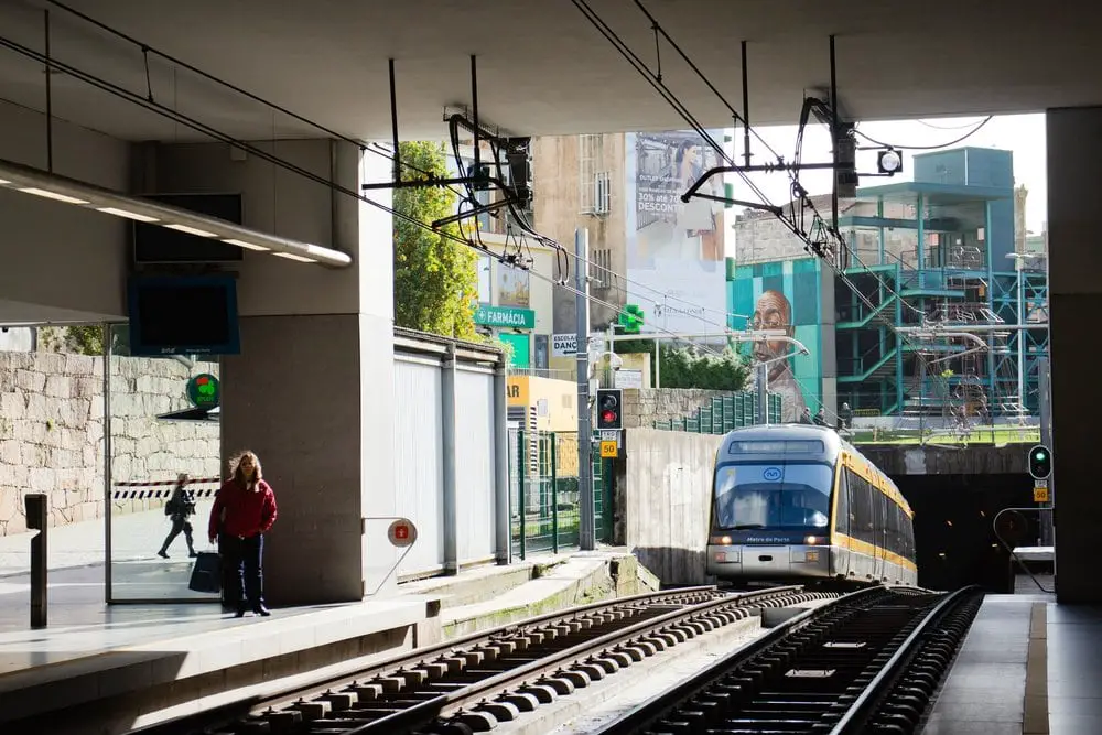 A train approaching a train station in Porto Portugal