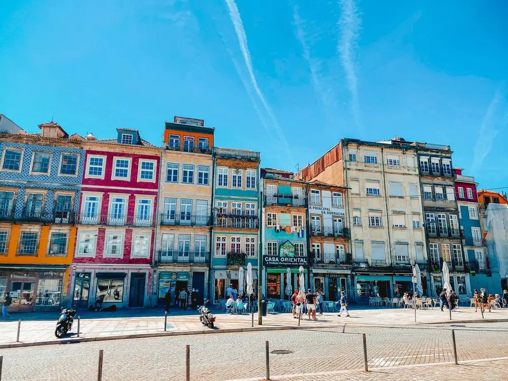 Bright and colourful buildings in the sunshine on a street in Porto Portugal