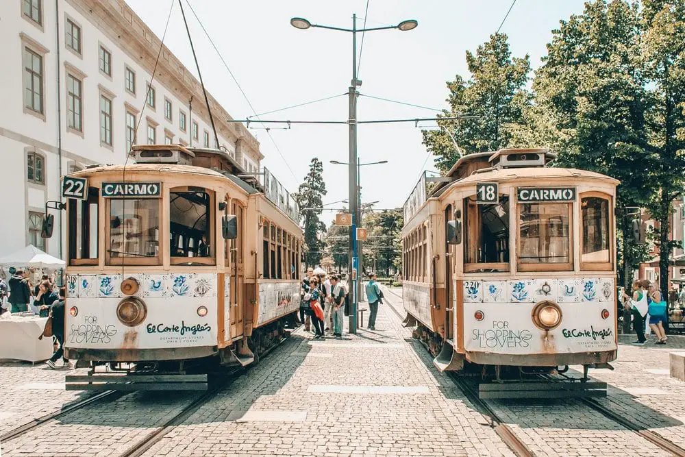 Two yellow and white trams in Porto