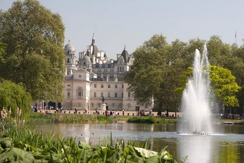 Fountains from the small lake in St James' Park, England, with St James' Palace and Clarence House in the background.