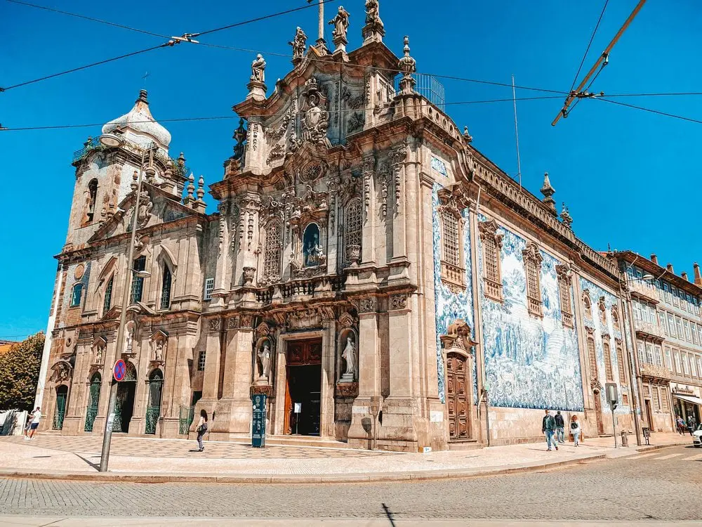 Exterior of a traditional church in Porto Portugal covered in blue and white azulejo tiles