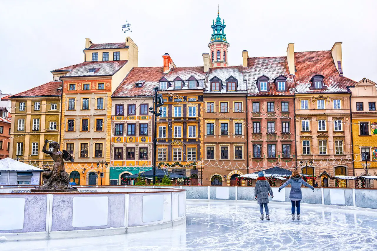 Ice skating rink in the Warsaw Old Town square in December at Christmas