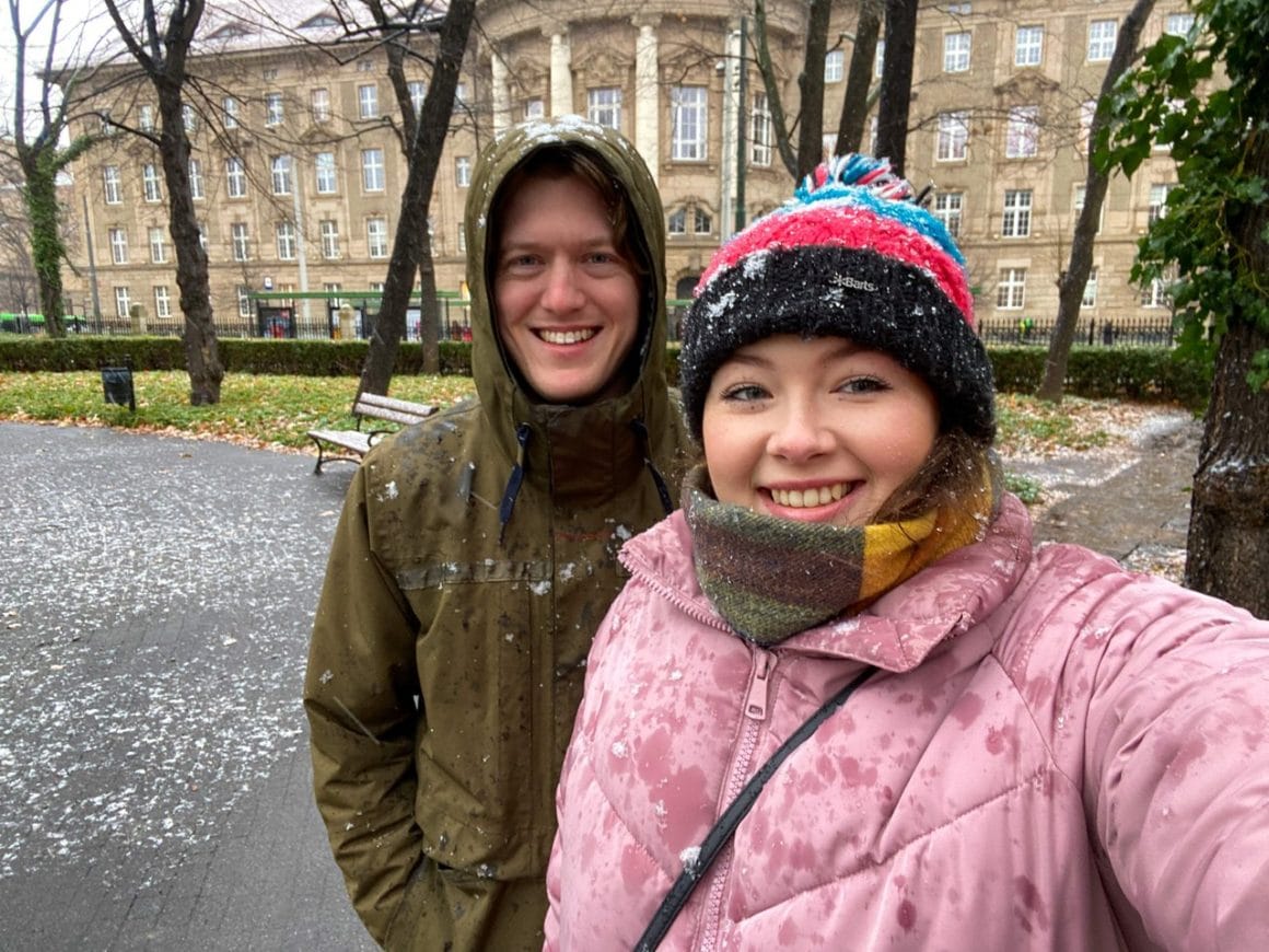 Ella takes a selfie with her boyfriend Rob snowflakes in the air, showcasing a winter day's exploration in Poznan, Poland.