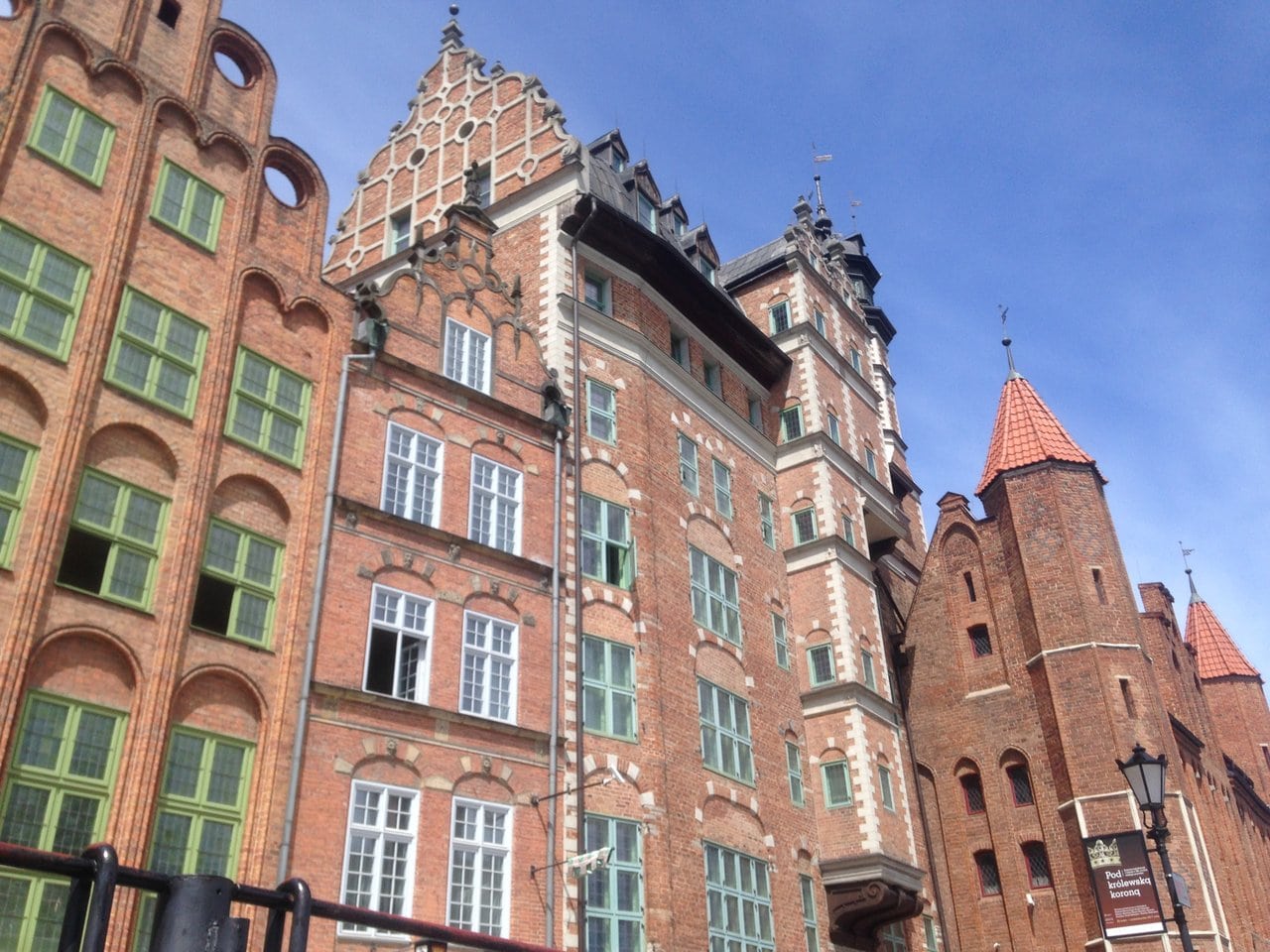 Intricate brickwork adorns the historical architecture of Gdansk, Poland, showcasing pointed gables and arched windows, a testament to the city's rich past.