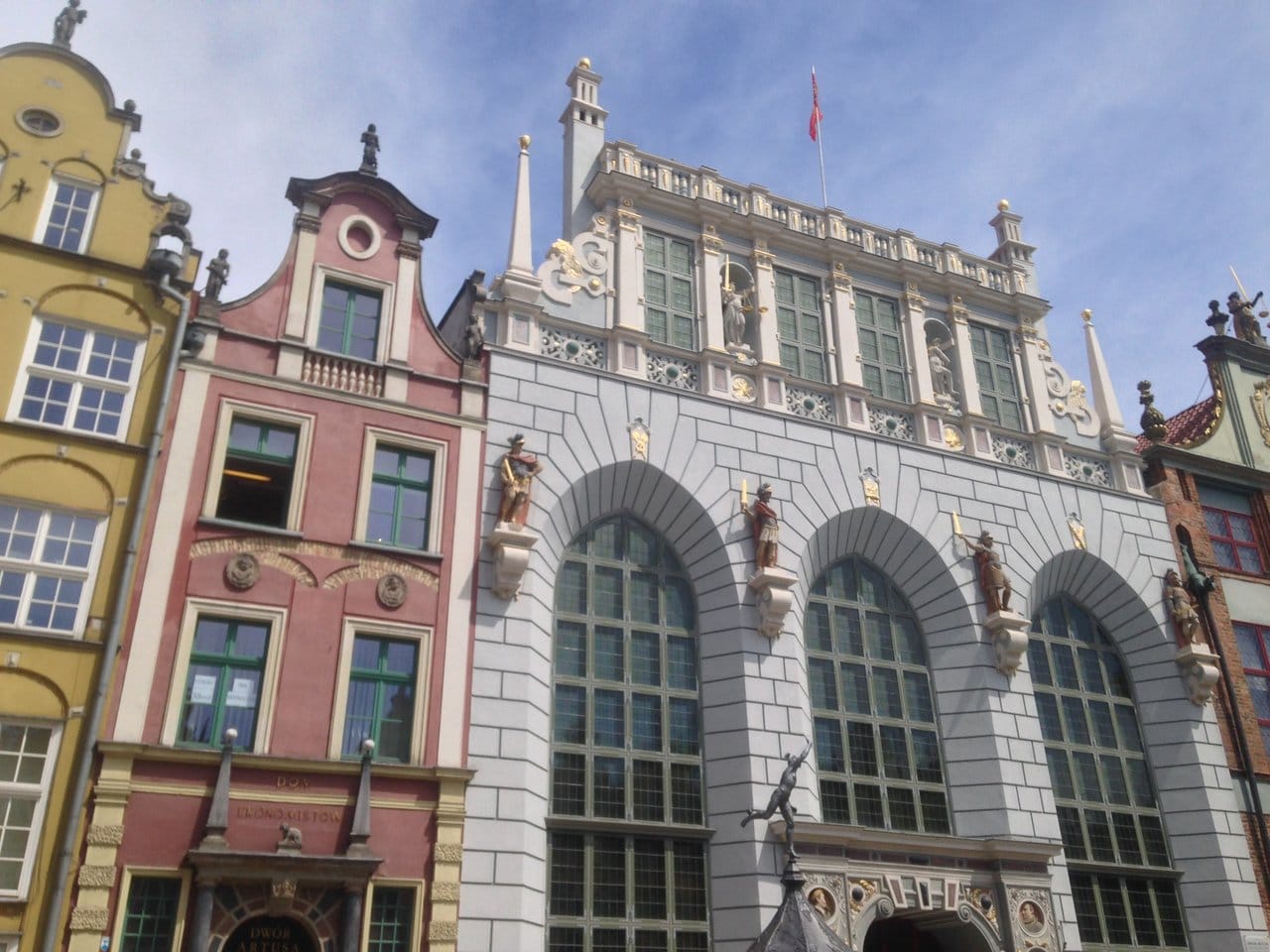 Colourful facades of traditional European architecture under a clear sky in Wroclaw Poland. The intricate details of sculptures and ornate designs adorn these historical buildings, highlighting the rich heritage and architectural beauty.