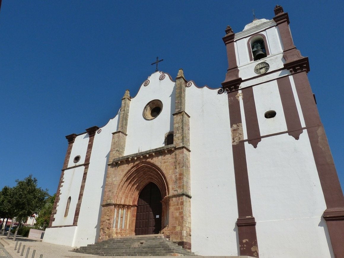 The white and pink facade of Silves Cathedral, one of the top attractions in Silves Portugal.