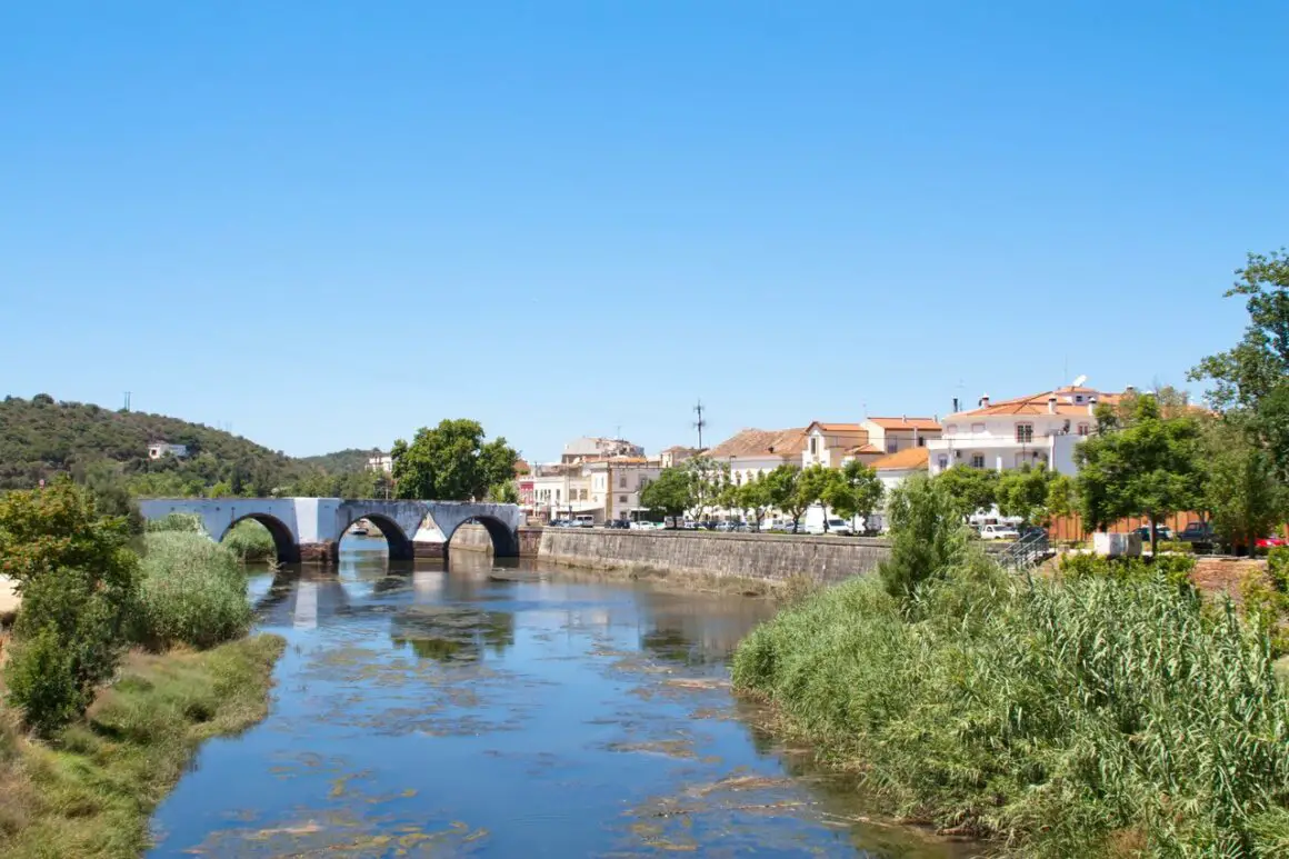 Arade River in Portugal, with the Roman Bridge stretching across it