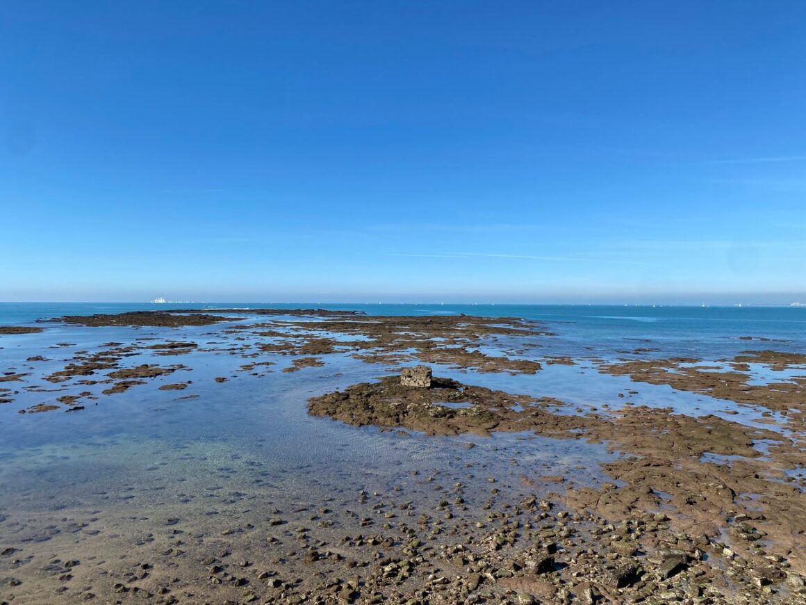 Cadiz Beach at Low Tide. Rocks and rockpools are exposed, with pools of water in them.