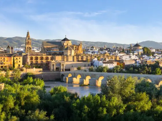 Cordoba old town, with the Guadalquivir and Roman Bridge in the foreground, both of which you will visit on this one day in Cordoba itinerary.