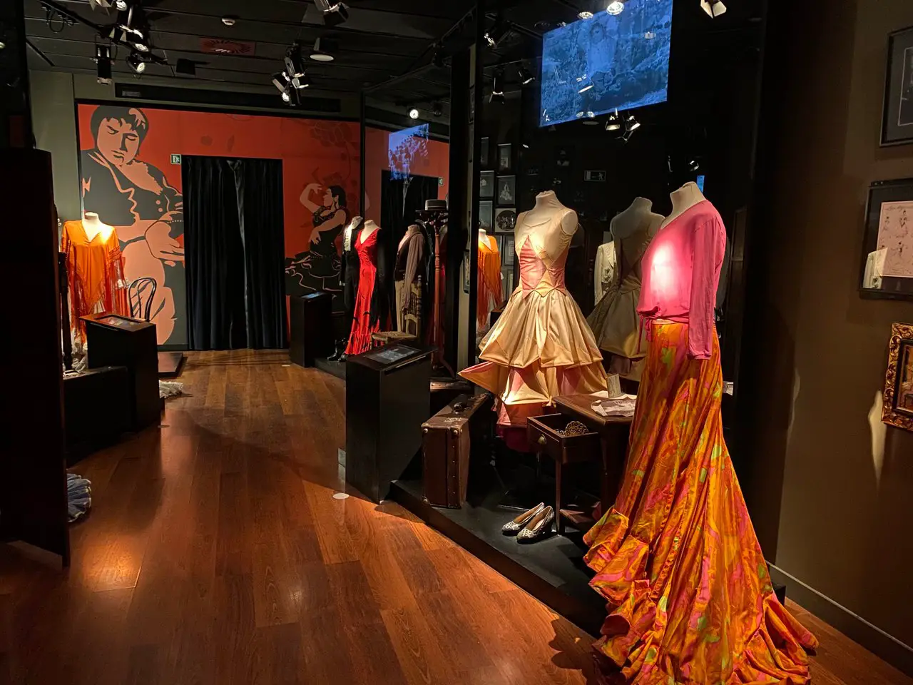 Interior of the Seville flamenco museum. There are three different flamenco dresses throughout history on display.