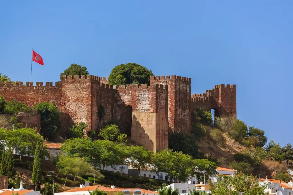 Silves Castle, with Moorish-style turrets, overlooking the town of Silves in the Algarve, Portugal.