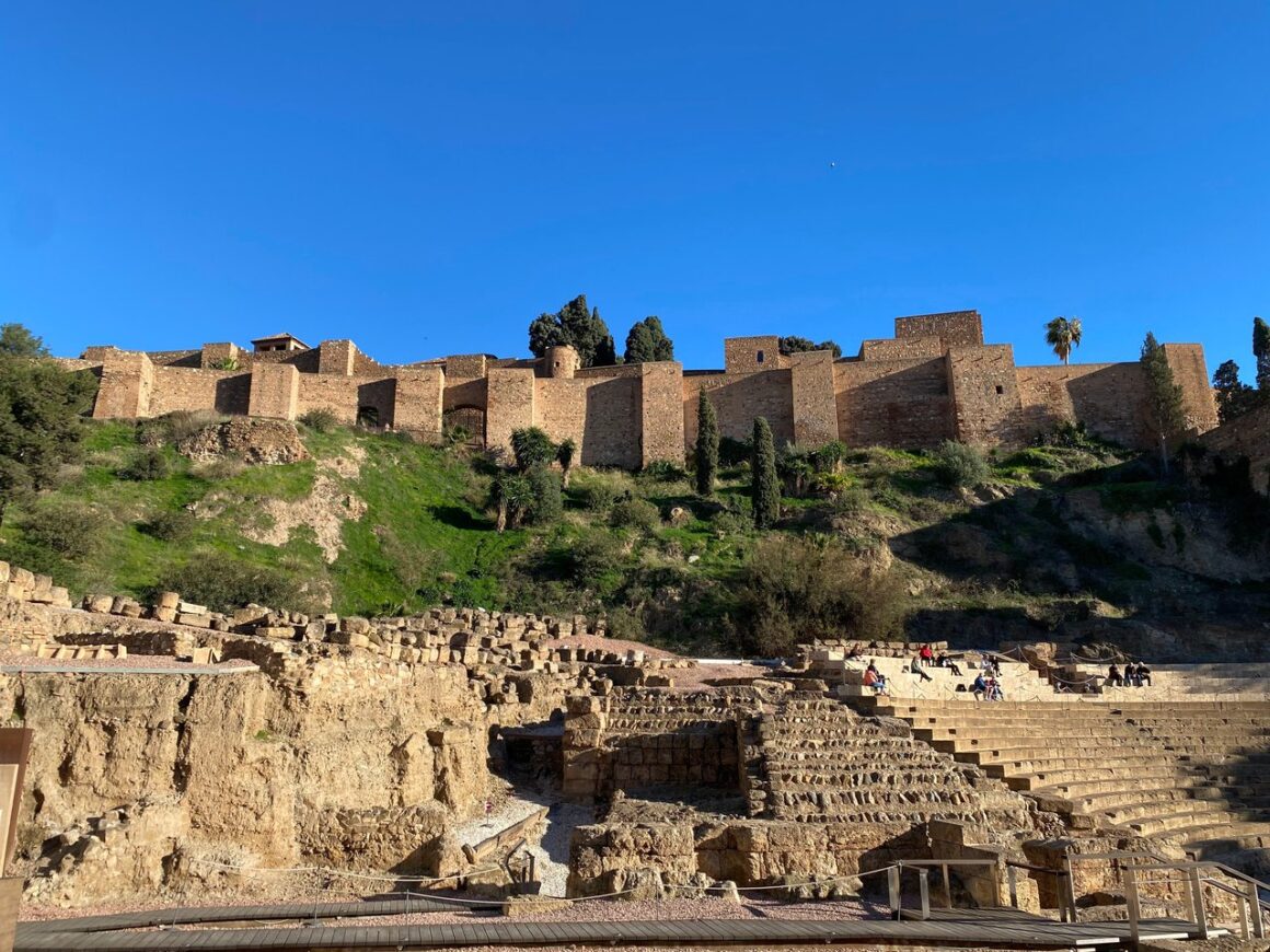 Moorish castle on top of a hill, with blue sky in the background.