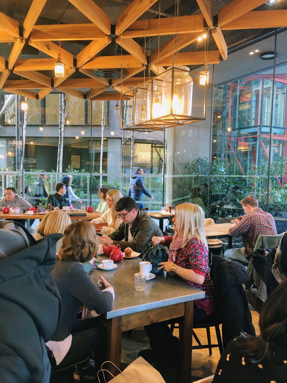 Inside Gail's Coffee Shop London Bankside. Many people are sitting around tables talking and drinking coffee