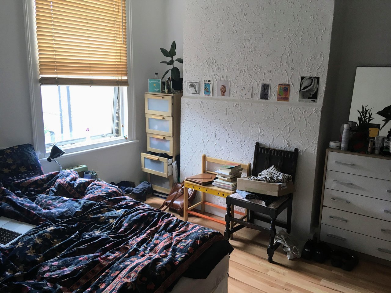 A small bedroom with a double bed and large window - this is an example of the type of room you can rent for £800 a month. The cost of living in London is crazy!