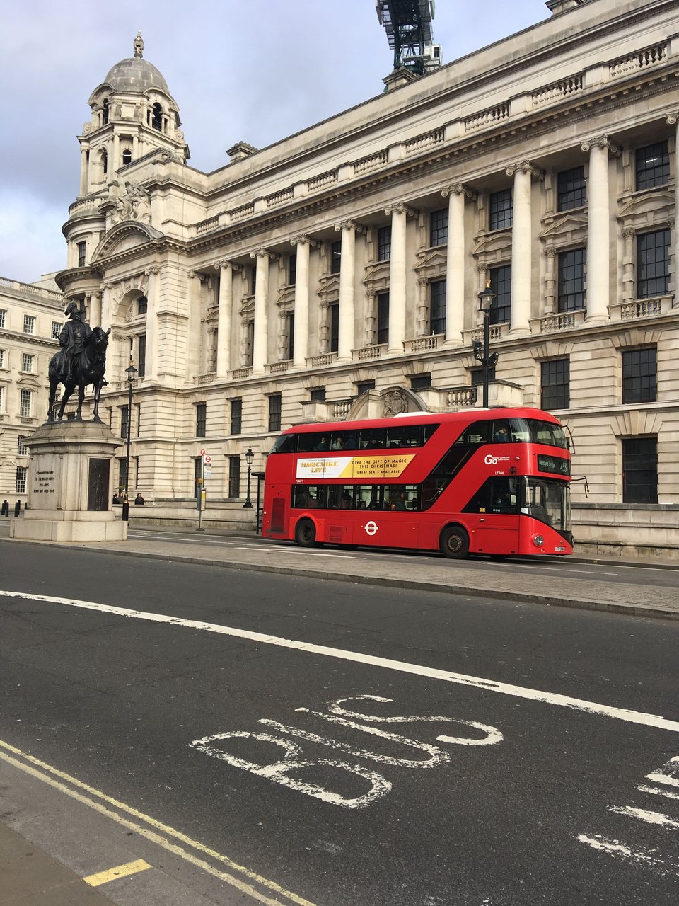 London red bus driving past a Georgian building