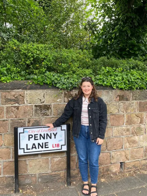 Ella at the Penny Lane street sign in Liverpool