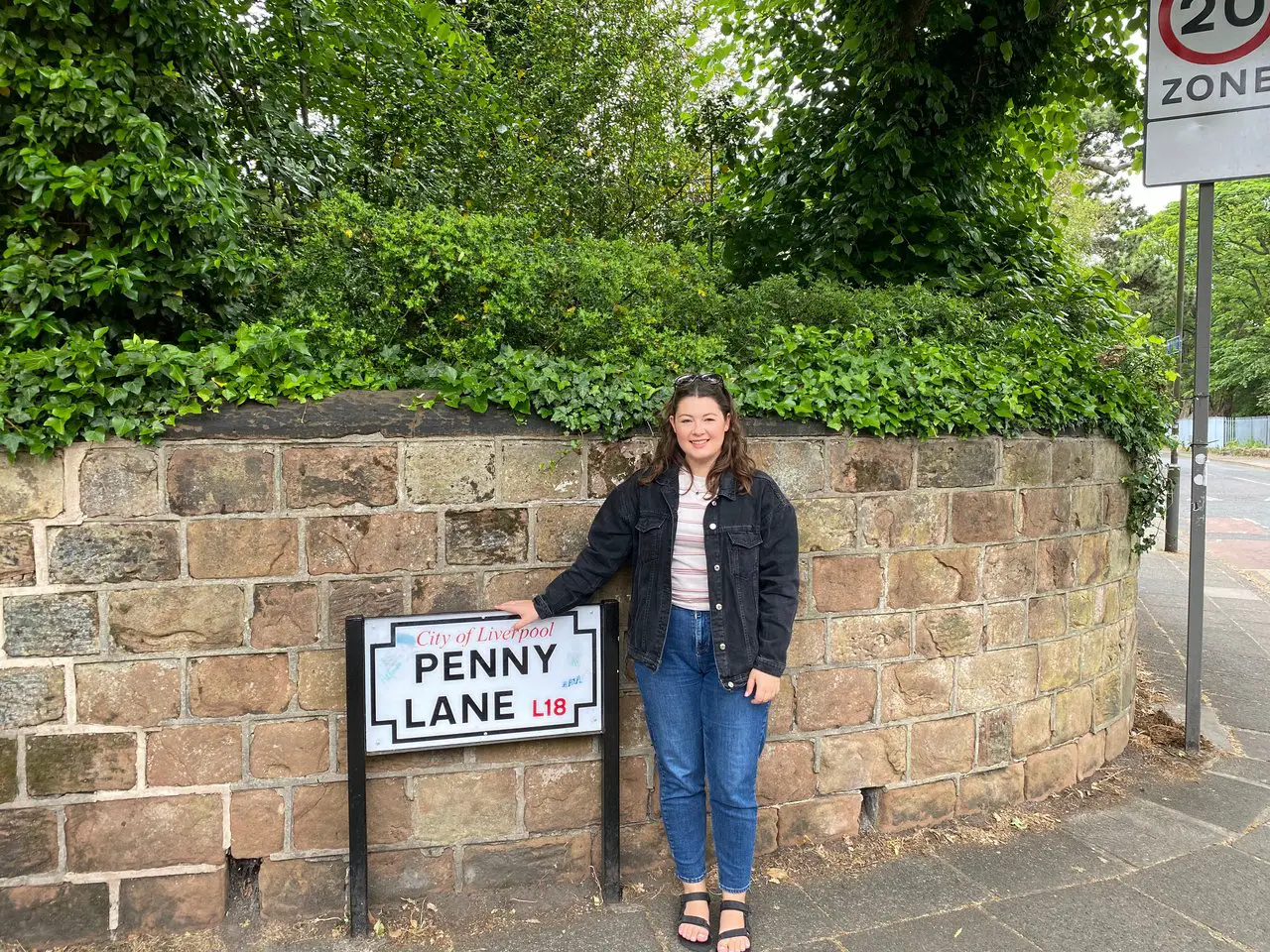 Ella at the Penny Lane street sign in Liverpool