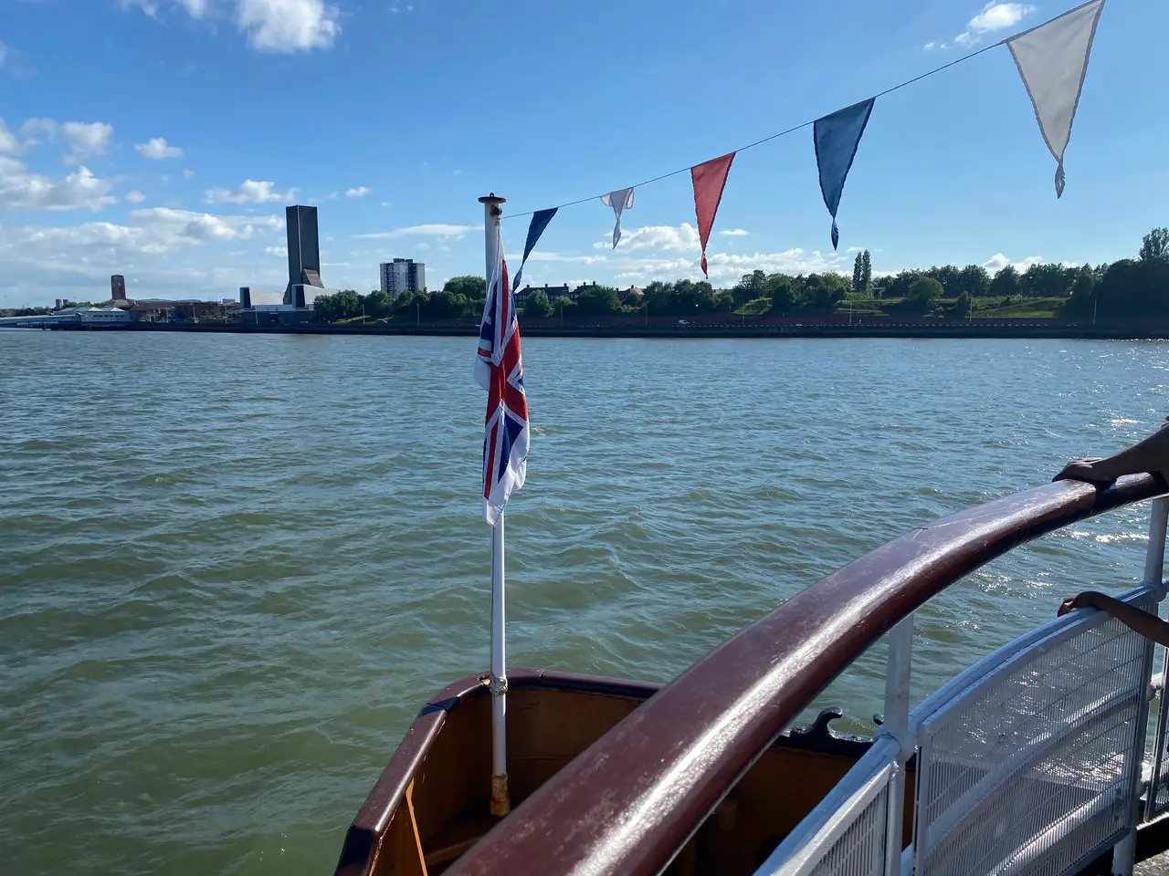 Flags fluttering on the breeze on the Mersey River Ferry