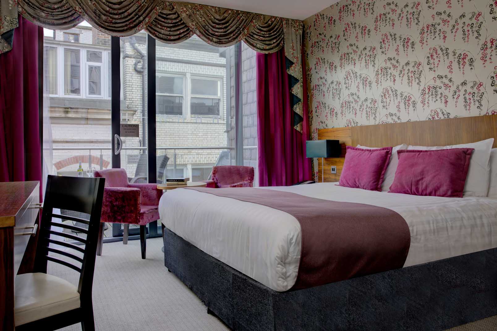 A pink-themed bedroom in Heywood House Hotel Liverpool