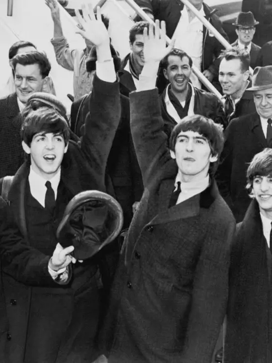 Black and white photo of the Beatles in the 1960s