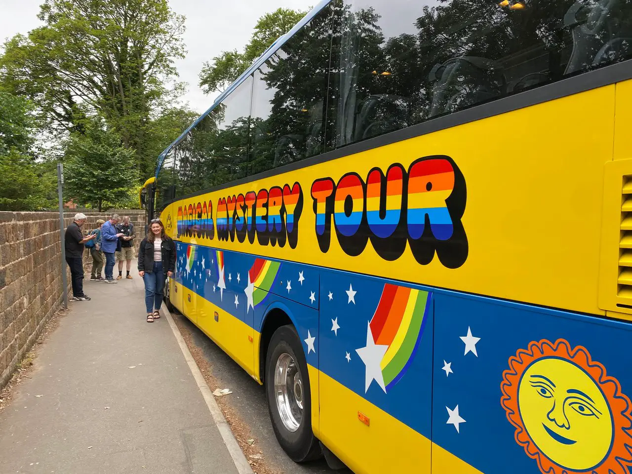 Ella with the yellow and blue Magical Mystery Tour bus in Liverpool