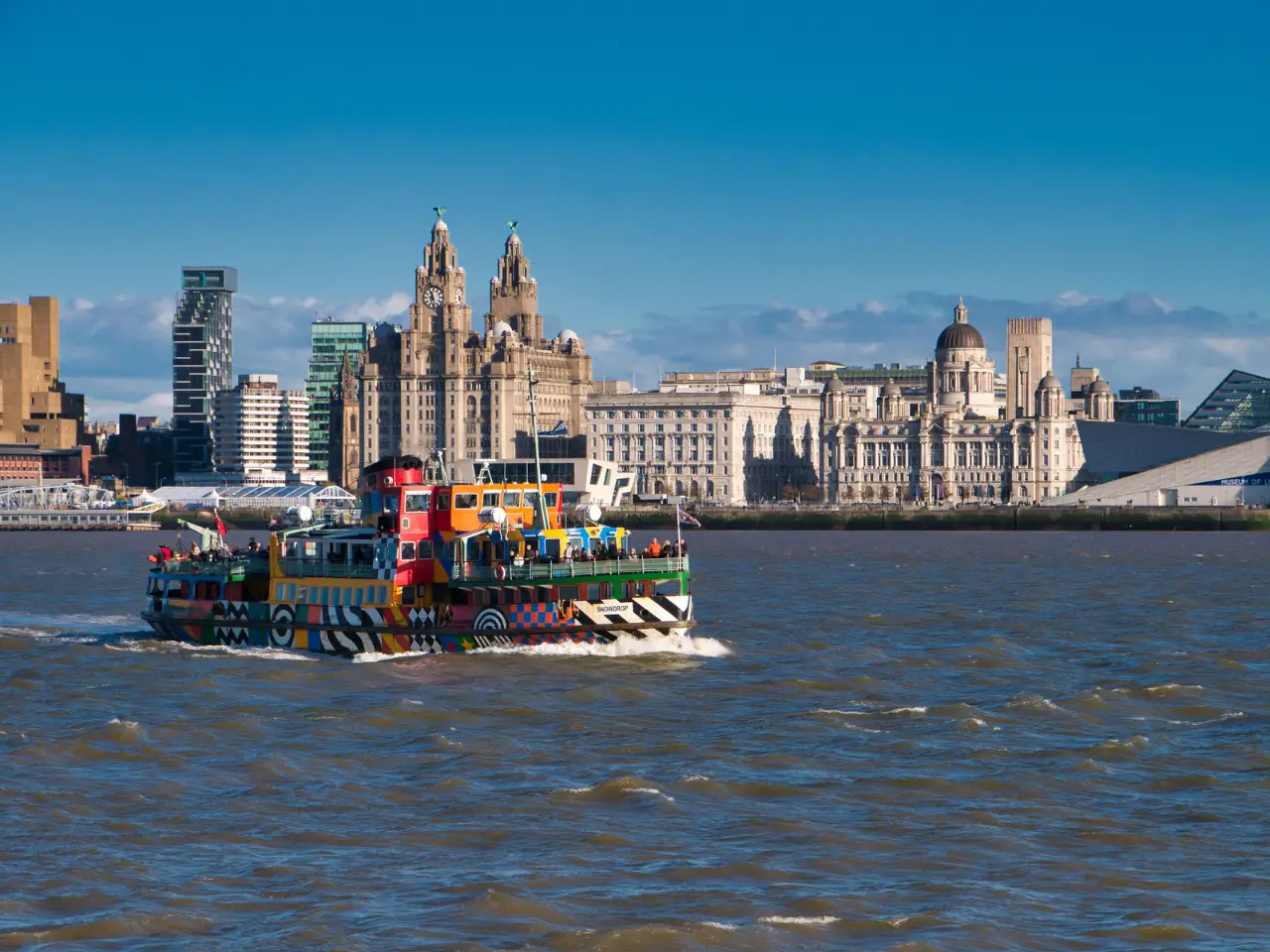 The Mersey Ferry sailing along the River Mersey in Liverpool with the Liver Building in the background