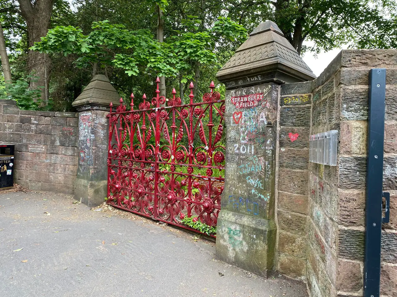 The red painted gates, covered in Beatles graffiti, at Strawberry Field in Liverpool