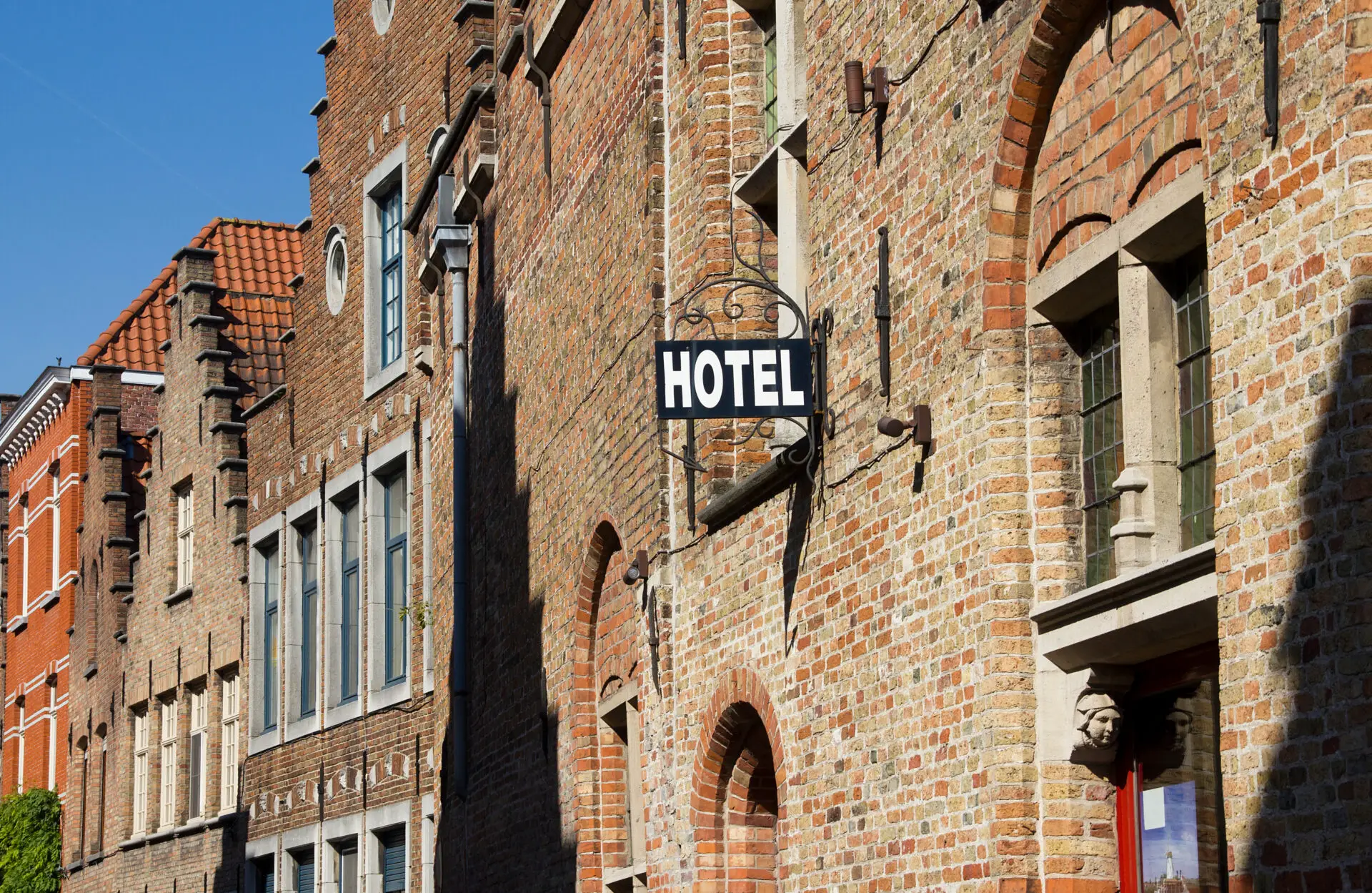 Sign saying Hotel in a Bruges street in Belgium