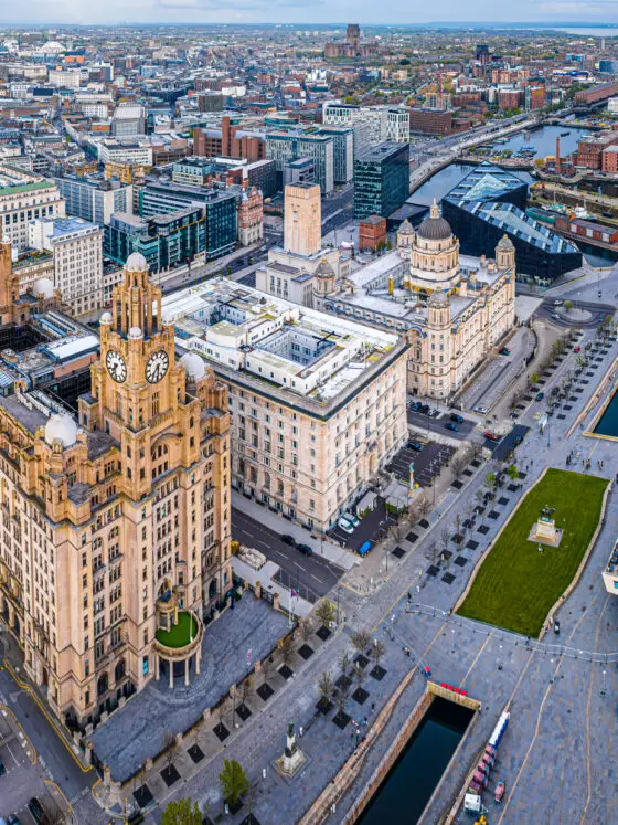 Aerial view of Liverpool waterfront showing the famous Liver Building and the Albert Dock in the distance. Beautiful buildings like this mean that Liverpool is worth visiting.