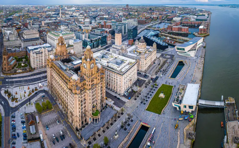 Aerial view of Liverpool waterfront showing the famous Liver Building and the Albert Dock in the distance. Beautiful buildings like this mean that Liverpool is worth visiting.