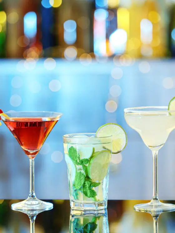 Glasses of fresh alcoholic cocktails on bar counter