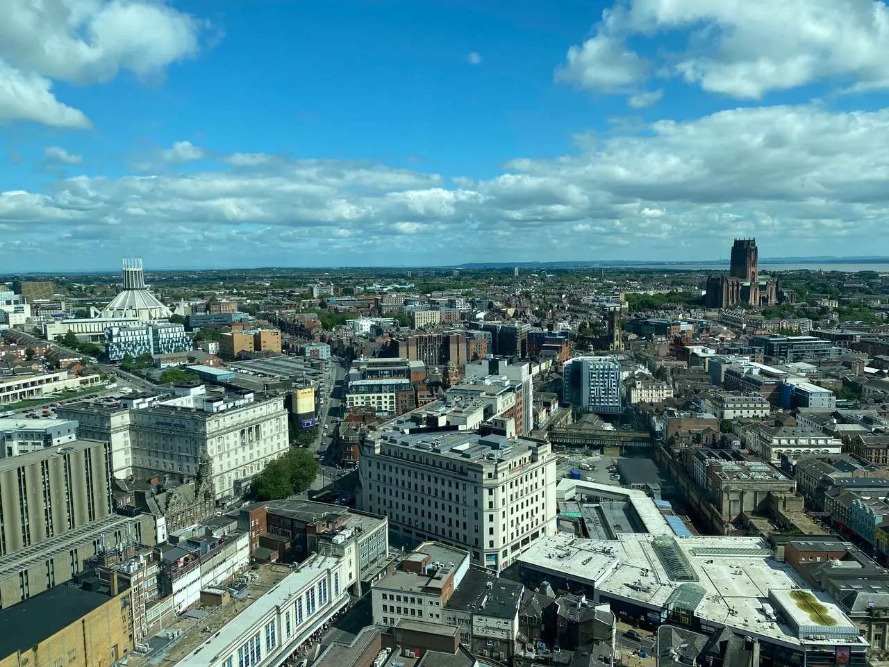 A view of the Liverpool city skyline, including the Liverpool Cathedral and the Liverpool Metropolitan Cathedral, from above, at the top of the St John's Beacon