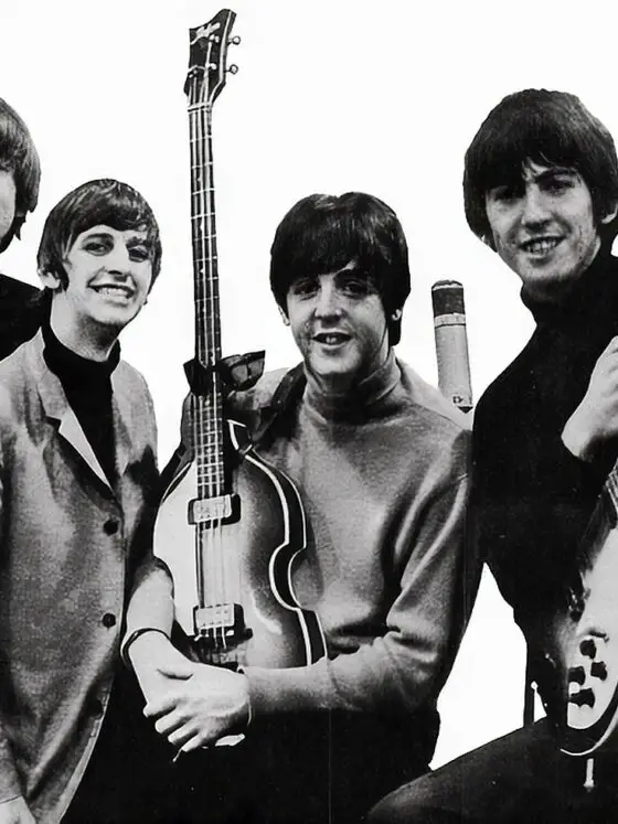 Black and white photo of the four Beatles holding their instruments - but did you know the original name of the Beatles was The Quarrymen?