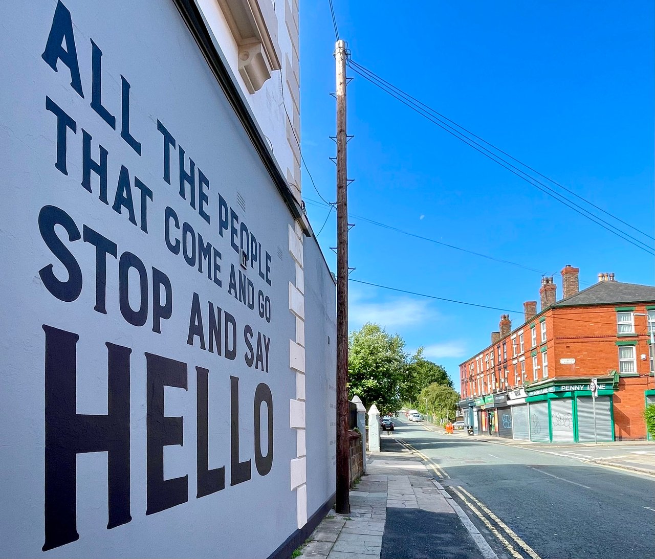 Penny Lane Beatles mural that says "all the people that come and go stop and say hello", which are lyrics from the song Penny Lane.
