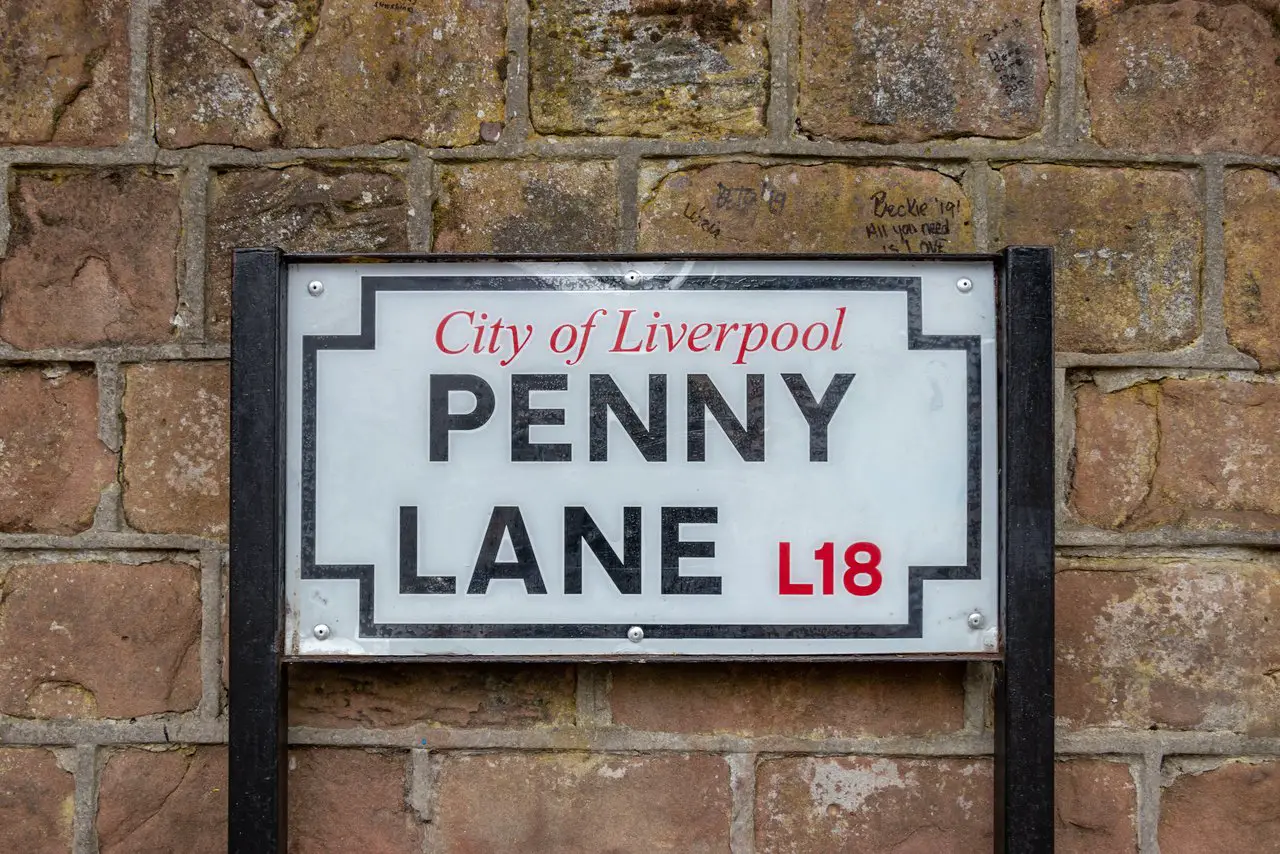 Penny Lane Liverpool England Street Sign against a brick wall.