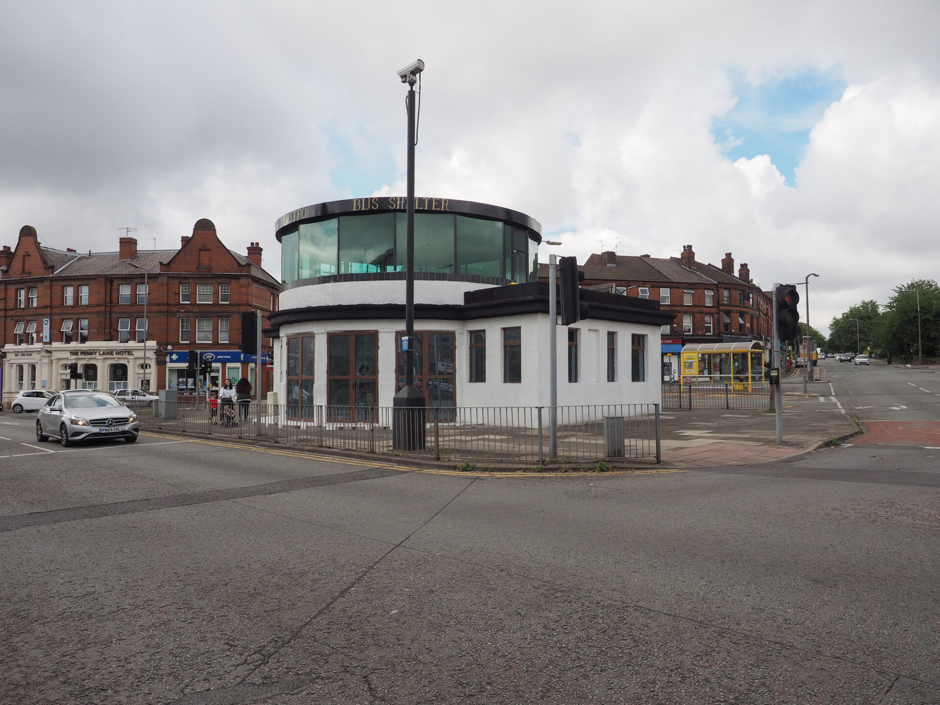Bus shelter in the middle of a roundabout in Penny Lane made famous by The Beatles song Penny Lane on their 1967 album Magical Mystery Tour