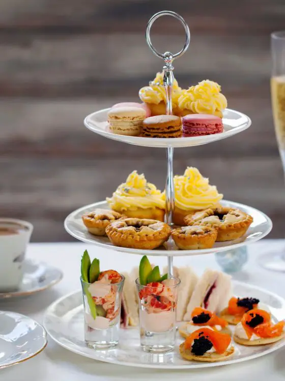 Three-tiered afternoon tea with two glasses of prosecco. Liverpool is one of the best places in the UK to get a boozy afternoon tea
